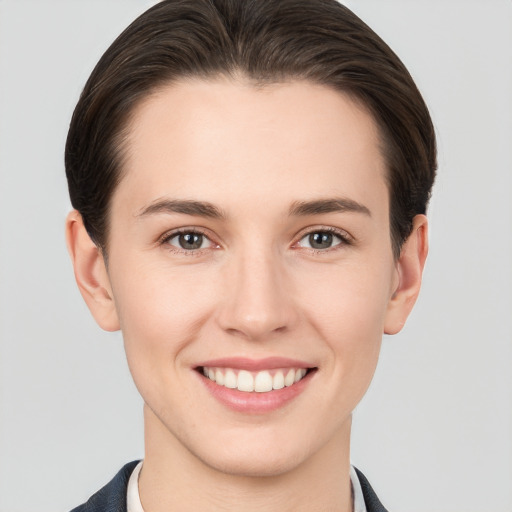 Joyful white young-adult female with short  brown hair and brown eyes