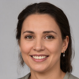 Joyful white adult female with medium  brown hair and brown eyes