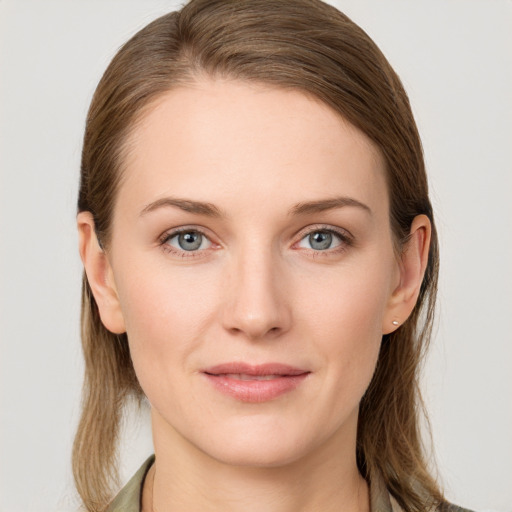 Joyful white young-adult female with long  brown hair and blue eyes