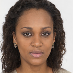 Neutral black young-adult female with long  brown hair and brown eyes