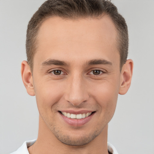 Joyful white young-adult male with short  brown hair and brown eyes