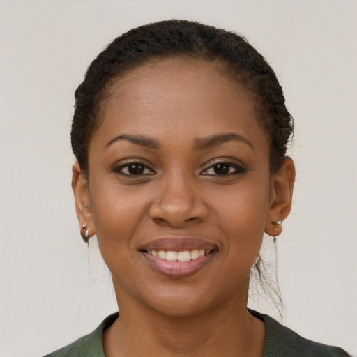 Joyful black young-adult female with short  brown hair and brown eyes