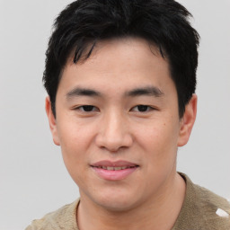 Joyful asian young-adult male with short  black hair and brown eyes