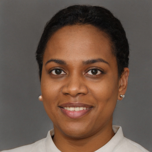 Joyful black young-adult female with short  brown hair and brown eyes