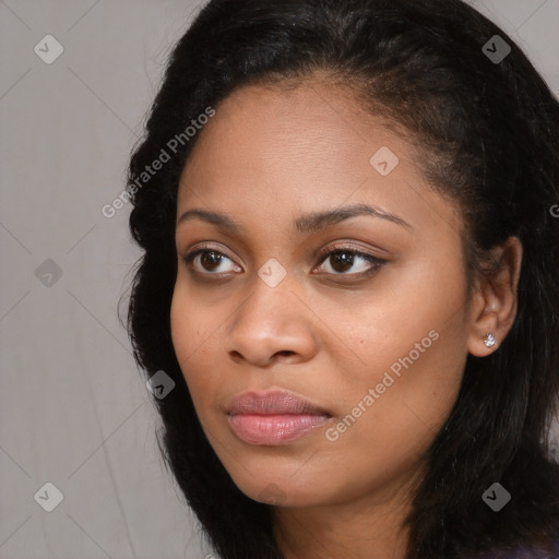 Joyful black young-adult female with long  black hair and brown eyes