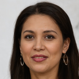 Joyful white adult female with long  brown hair and brown eyes