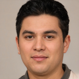 Joyful white young-adult male with short  black hair and brown eyes