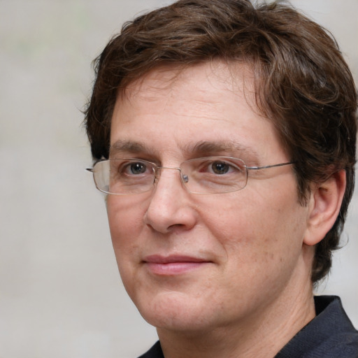 Joyful white adult male with medium  brown hair and grey eyes