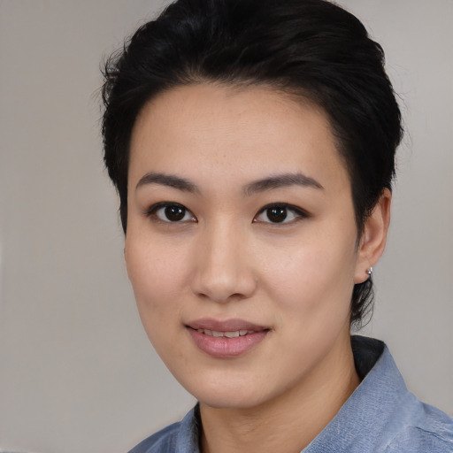 Joyful asian young-adult female with medium  black hair and brown eyes