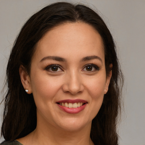 Joyful white young-adult female with long  brown hair and brown eyes