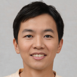 Joyful asian young-adult male with short  brown hair and brown eyes