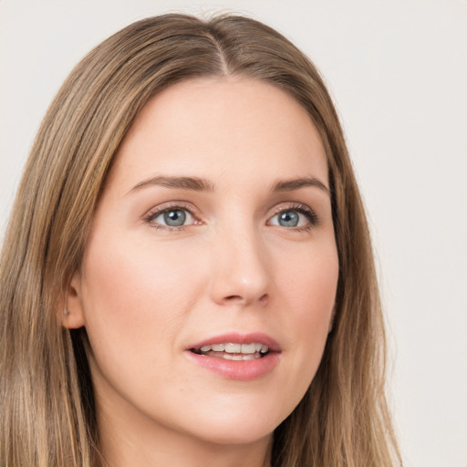 Joyful white young-adult female with long  brown hair and green eyes