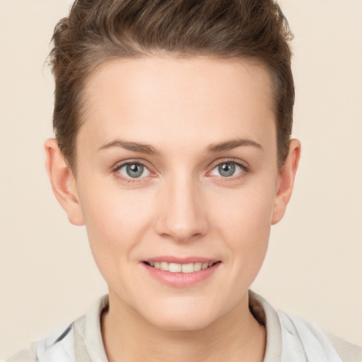 Joyful white young-adult female with short  brown hair and grey eyes