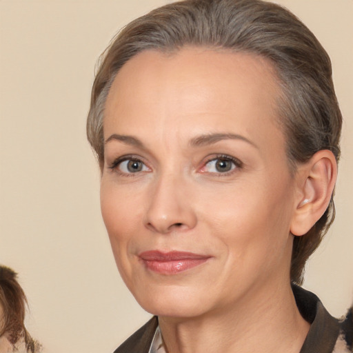 Joyful white adult female with medium  brown hair and brown eyes