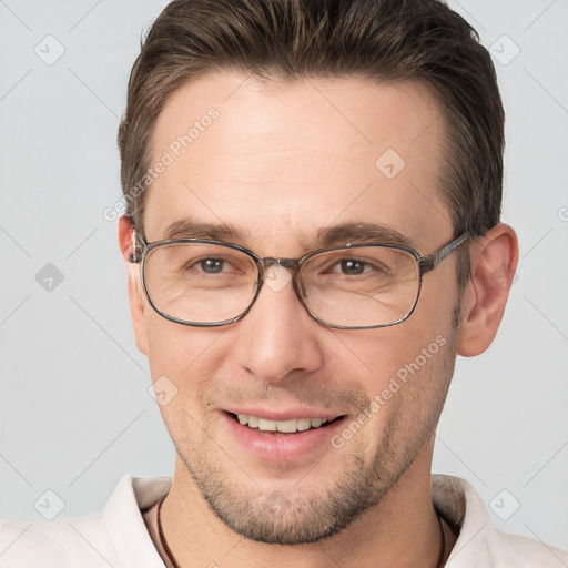 Joyful white adult male with short  brown hair and brown eyes