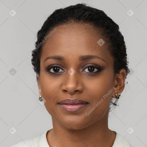 Joyful black young-adult female with short  black hair and brown eyes