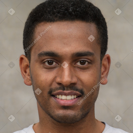 Joyful black young-adult male with short  brown hair and brown eyes