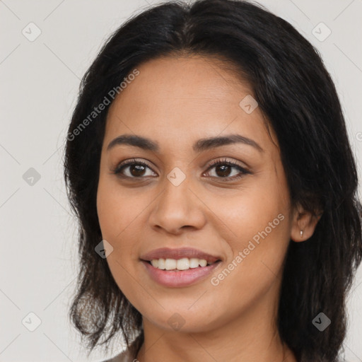 Joyful latino young-adult female with long  brown hair and brown eyes