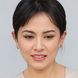 Joyful asian young-adult female with medium  brown hair and brown eyes