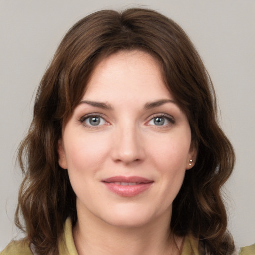 Joyful white young-adult female with medium  brown hair and grey eyes