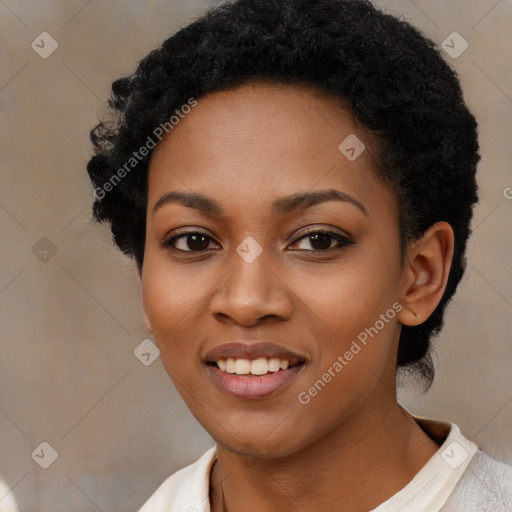 Joyful black young-adult female with short  black hair and brown eyes