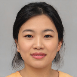 Joyful asian young-adult female with medium  brown hair and brown eyes