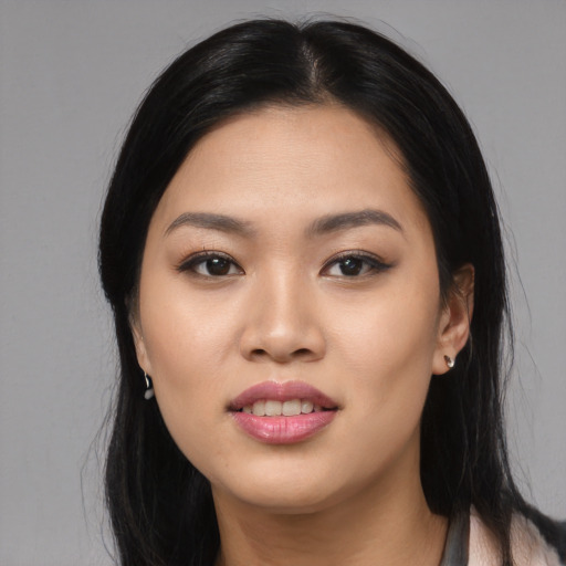 Joyful asian young-adult female with long  black hair and brown eyes