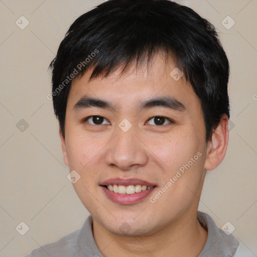 Joyful asian young-adult male with short  brown hair and brown eyes