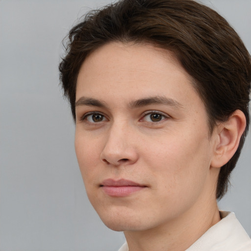 Joyful white young-adult female with short  brown hair and brown eyes