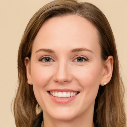 Joyful white young-adult female with long  brown hair and brown eyes