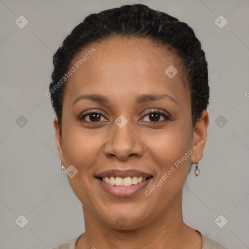 Joyful black adult female with short  brown hair and brown eyes