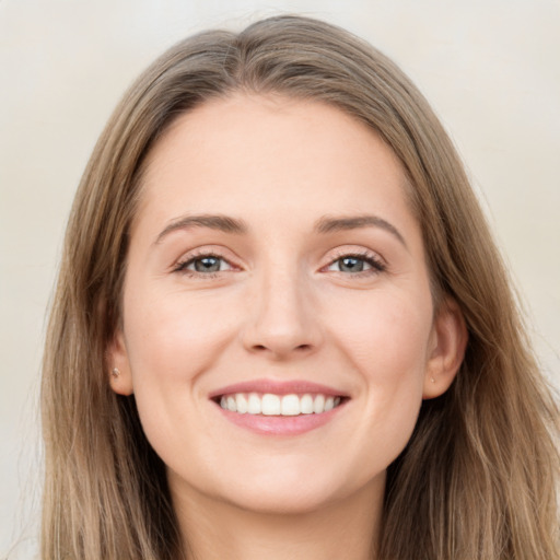 Joyful white young-adult female with long  brown hair and grey eyes