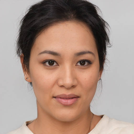 Joyful asian young-adult female with medium  brown hair and brown eyes