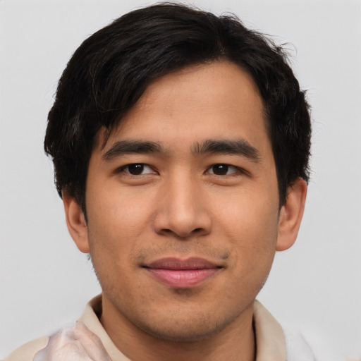 Joyful asian young-adult male with short  brown hair and brown eyes