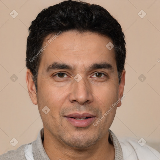 Joyful white adult male with short  black hair and brown eyes