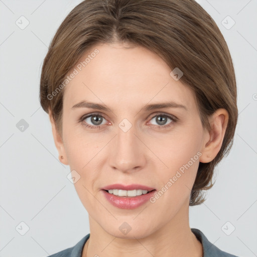 Joyful white young-adult female with medium  brown hair and grey eyes