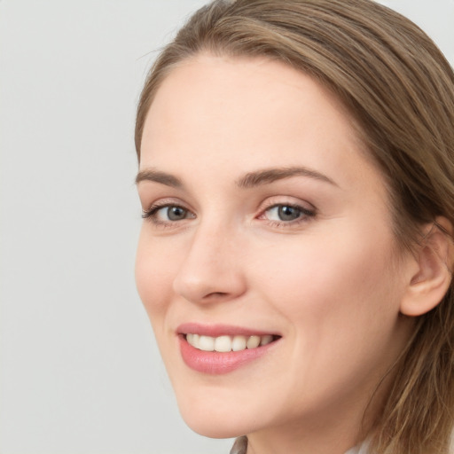 Joyful white young-adult female with long  brown hair and grey eyes