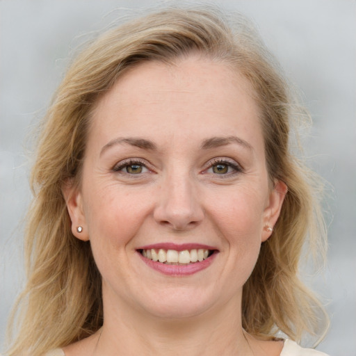 Joyful white young-adult female with medium  brown hair and blue eyes