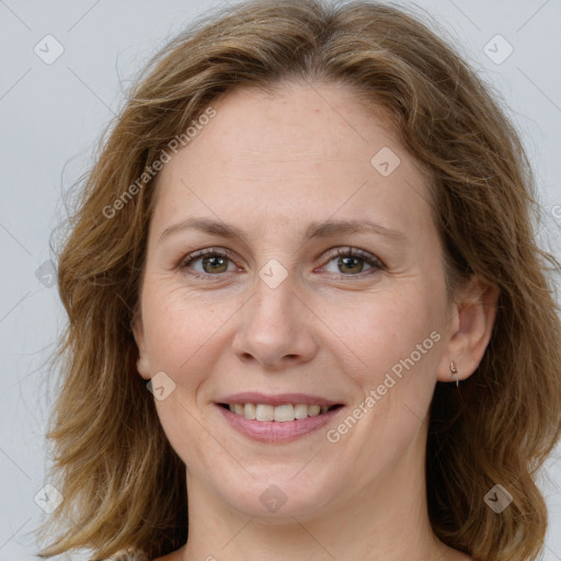 Joyful white adult female with long  brown hair and green eyes