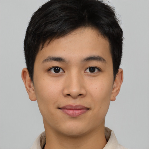 Joyful asian young-adult male with short  brown hair and brown eyes