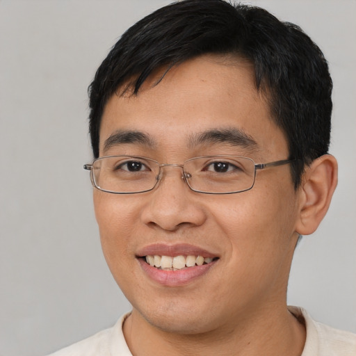 Joyful asian young-adult male with short  brown hair and brown eyes