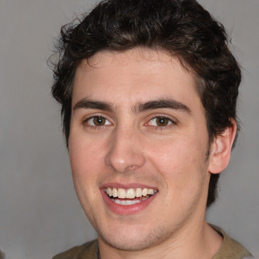 Joyful white young-adult male with medium  brown hair and brown eyes