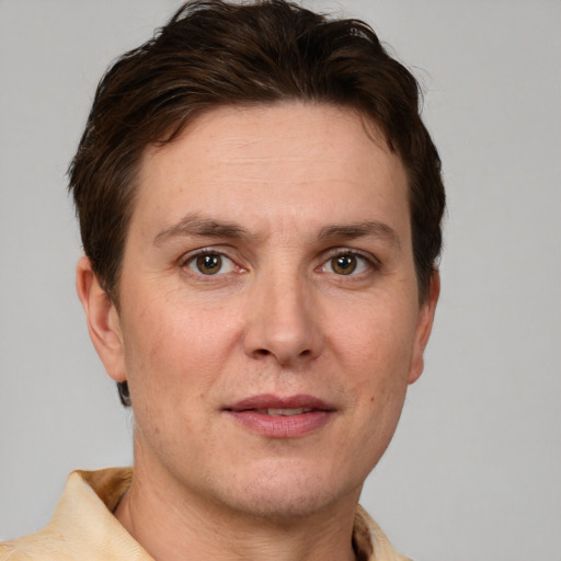 Joyful white adult male with short  brown hair and grey eyes