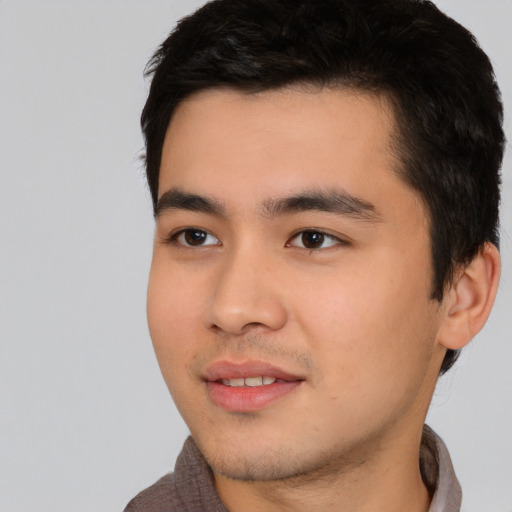 Joyful asian young-adult male with short  black hair and brown eyes