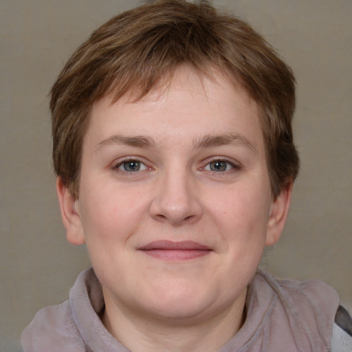 Joyful white young-adult female with short  brown hair and grey eyes