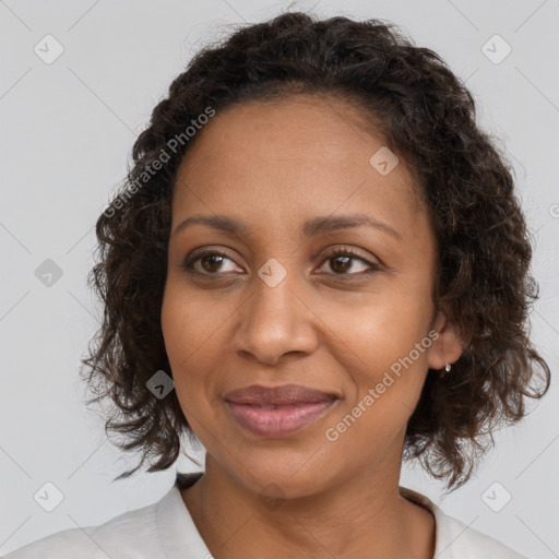 Joyful black adult female with medium  brown hair and brown eyes