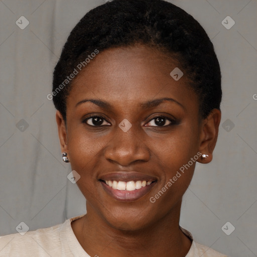 Joyful black young-adult female with short  black hair and brown eyes