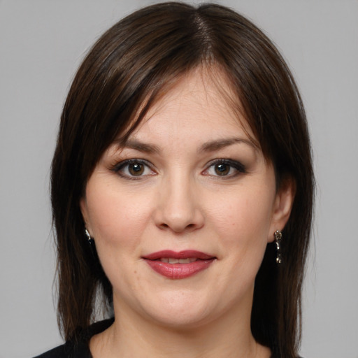 Joyful white young-adult female with medium  brown hair and brown eyes