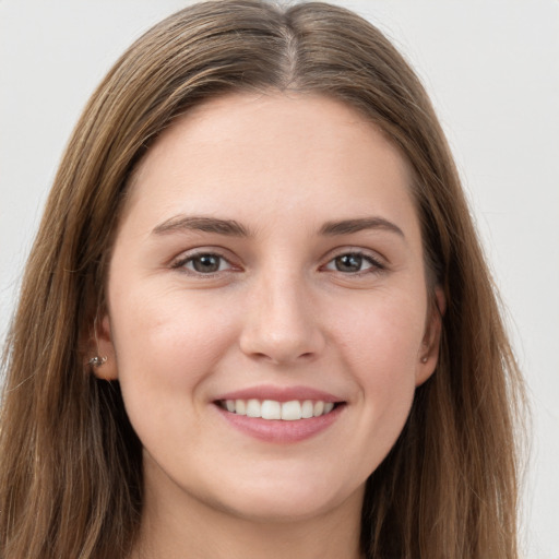 Joyful white young-adult female with long  brown hair and grey eyes