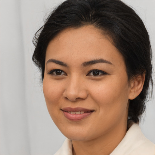 Joyful asian young-adult female with medium  brown hair and brown eyes